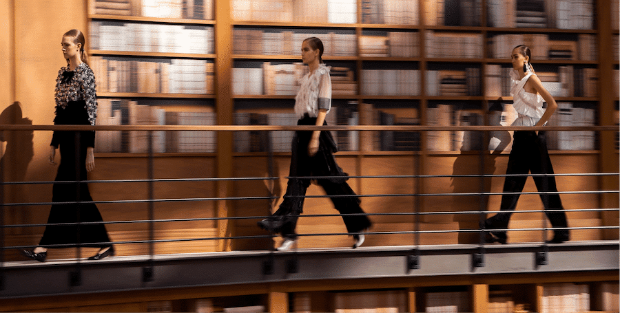 image taken by launchmetrics spotlight photographer showing three women walking on a runway