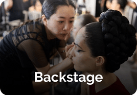 woman doing makeup backstage